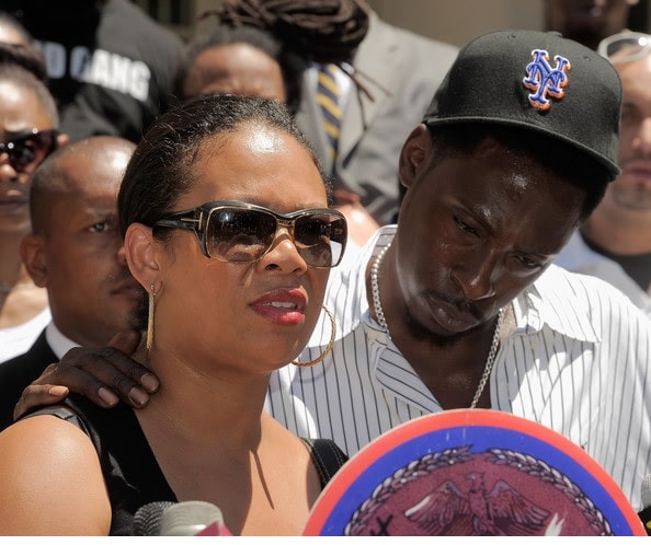 Pete Rock putting his hand on his wife's shoulder